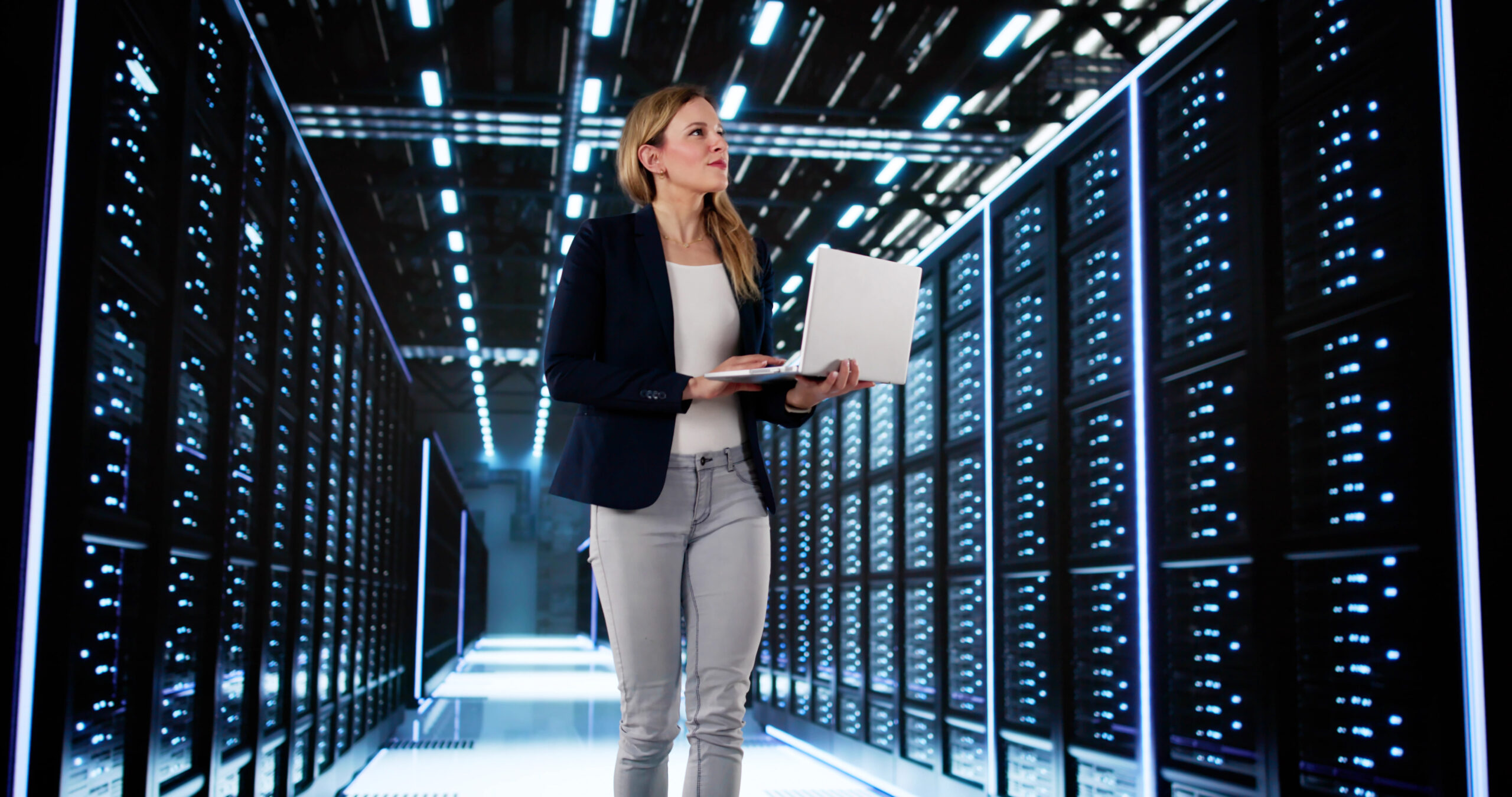 Smiling Woman Managing Data Center Server Room For AI Configuration